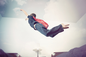 Kid wearing a cape and flying