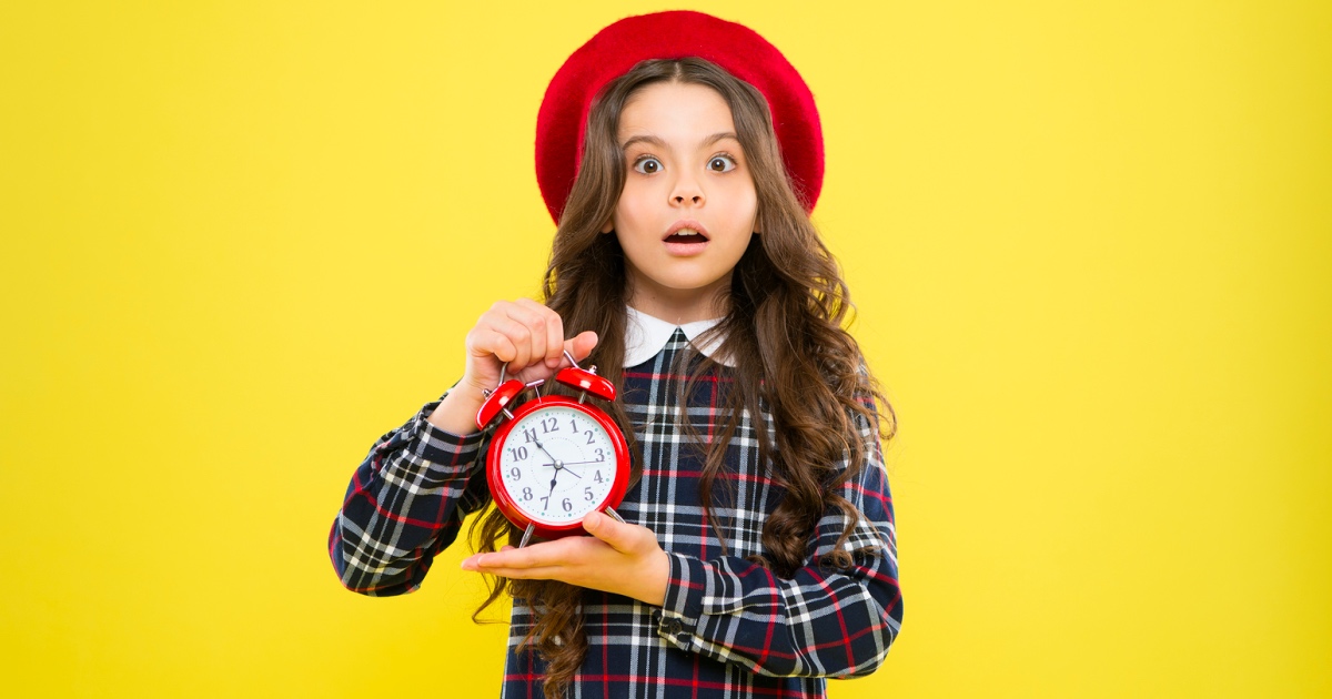 Woman holding an alarm clock