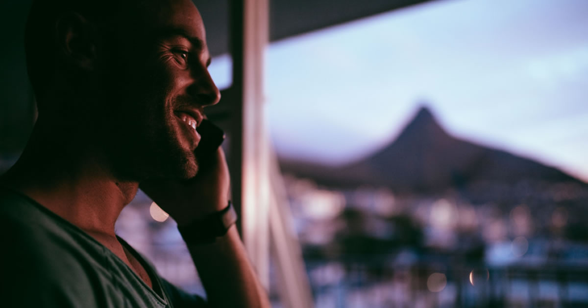 Smiling man talking on mobile phone