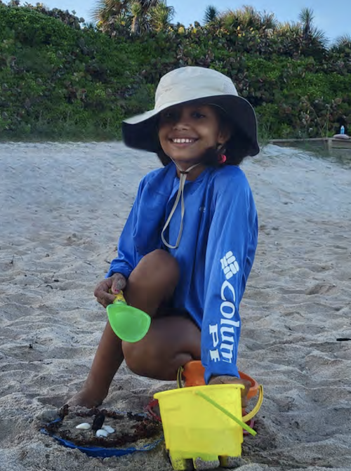 Shameka&rsquo;s daughter plays in the sand in Delray Beach, Florida