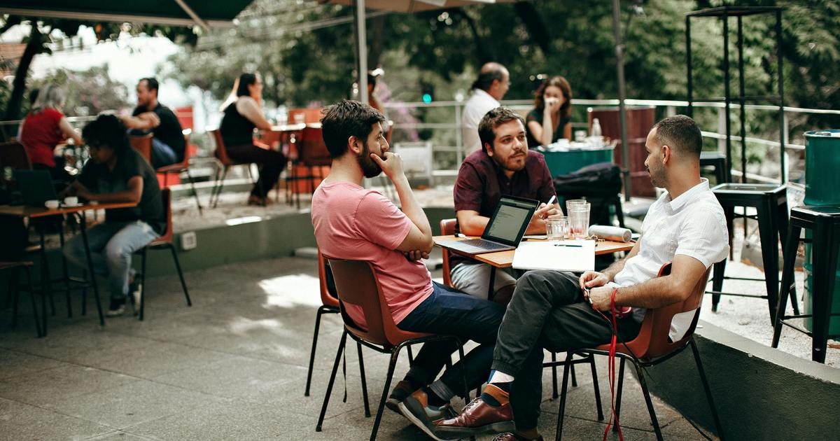 Group of writers sitting at a table outside