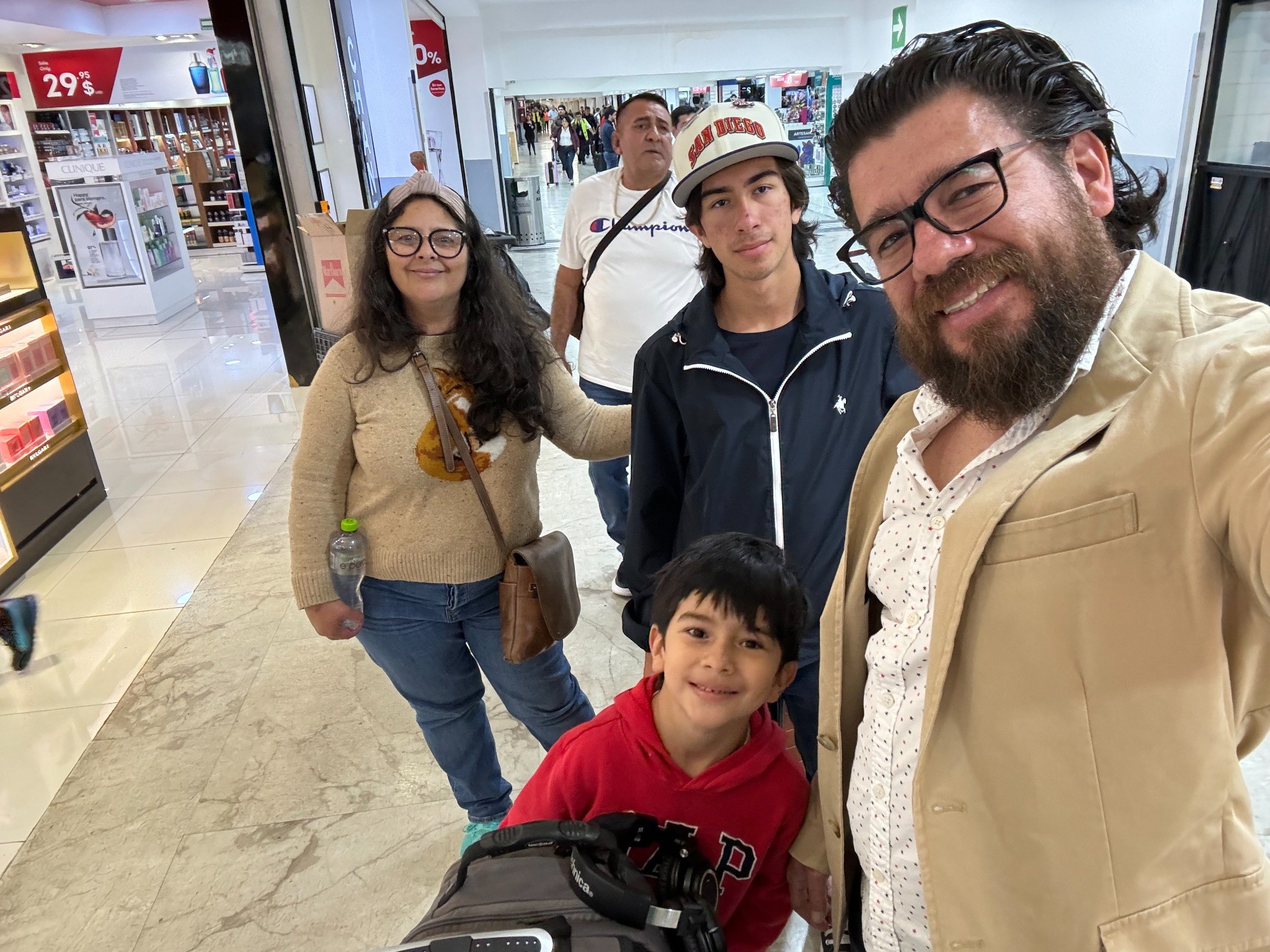 Edgar (right) with his wife, Tania, older son Dante, and younger son Enzo, at the airport headed for their new home in Cuernavaca, Mexico.